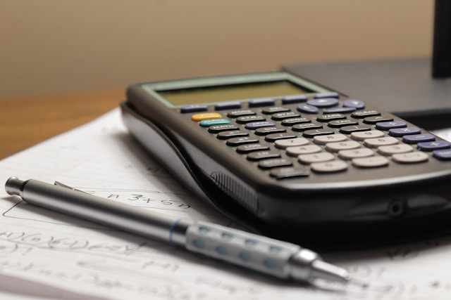 Dossier et calculatrice posés sur une table
